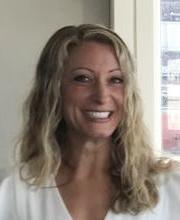 headshot photo of Amanda Barudin Carreiro smiling with long wavy dirty blonde hair wearing a v-neck white top